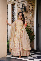 Woman in a beige, embroidered Anarkali gown.